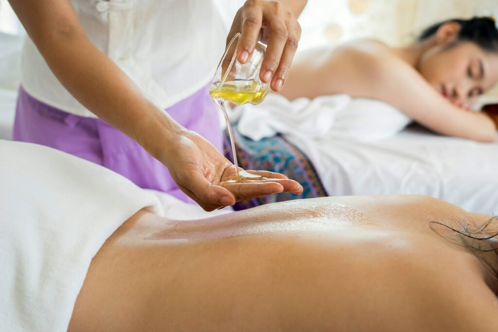 Therapist applying pressure along a guest upper back and neck during spine relief treatment