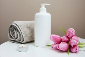 Warm towels and stones laid out in a dim treatment room at Silk and Spine head spa