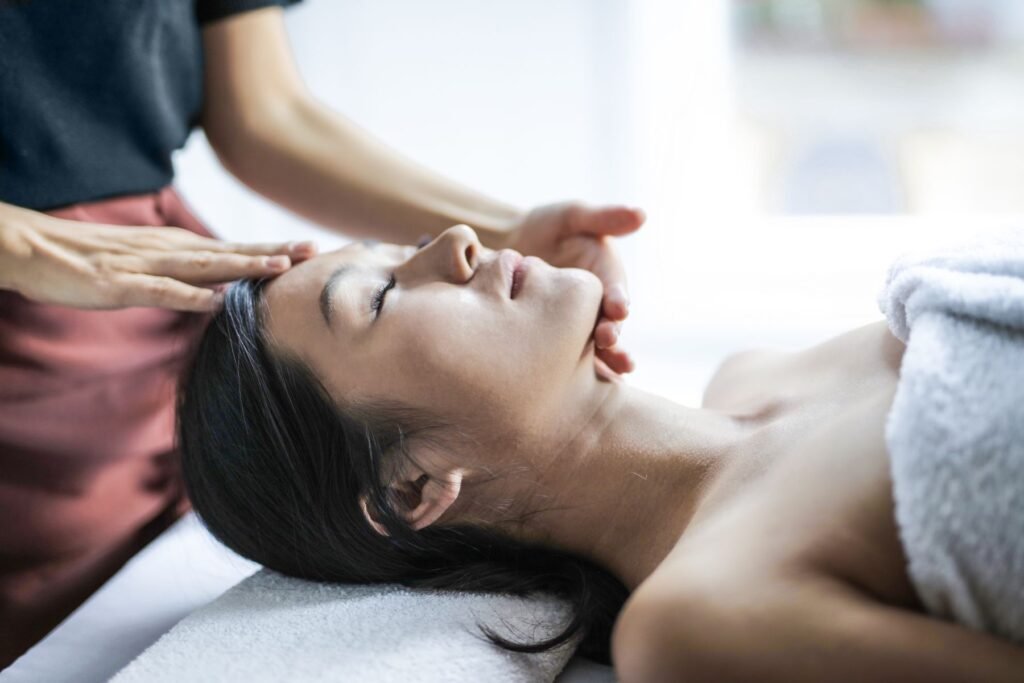 A guest resting on a treatment table during a head massage